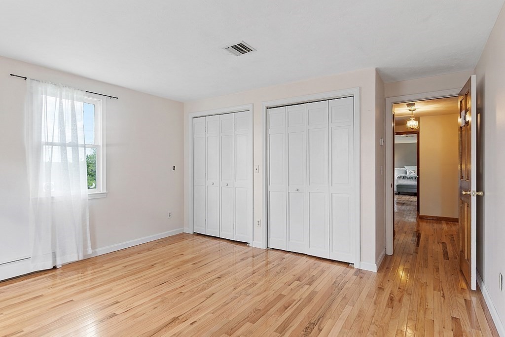 198 Still River Road Bolton, MA 01740 - Photo 27 of 36 a view of a room with wooden floor and a window