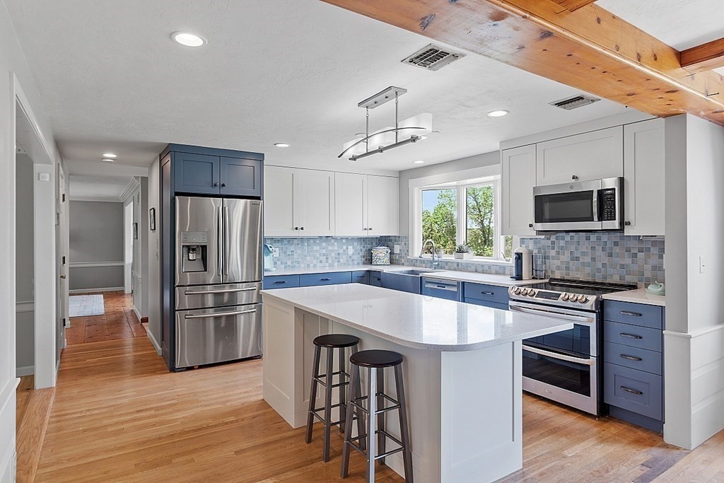 198 Still River Road Bolton, MA 01740 - Photo 3 of 36 a kitchen with stainless steel appliances a stove a sink island and a refrigerator