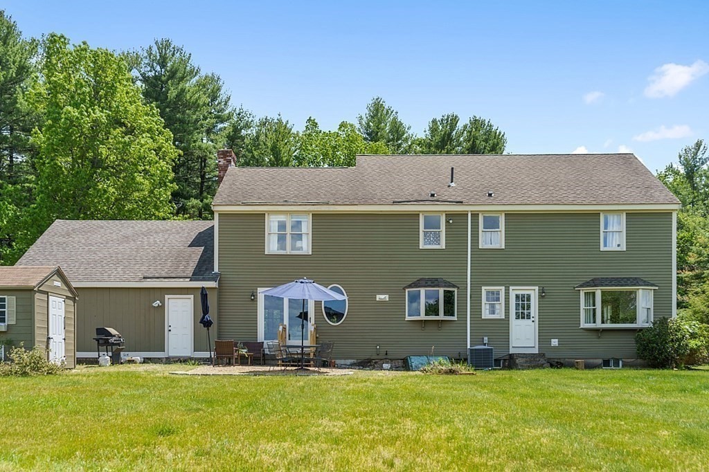 198 Still River Road Bolton, MA 01740 - Photo 34 of 36 a front view of house with yard and trees in the background