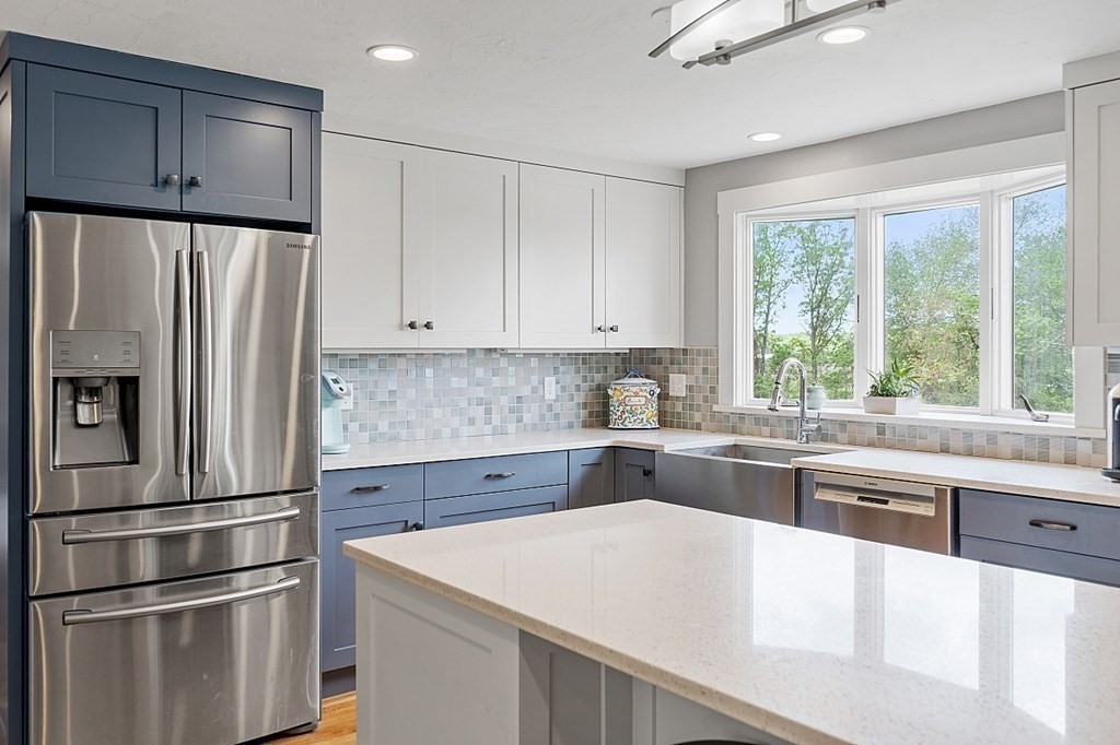 198 Still River Road Bolton, MA 01740 - Photo 4 of 36 a kitchen with a refrigerator a sink and cabinets