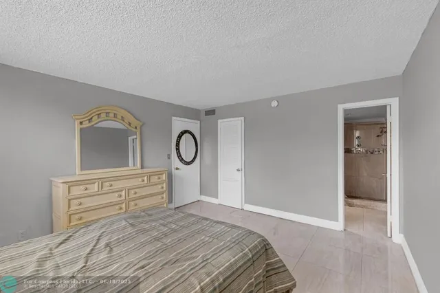 a bedroom with a bed and a closet with wooden floor