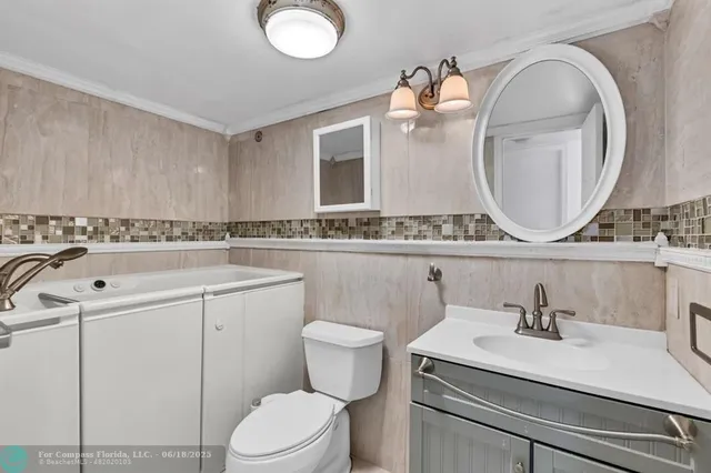 a bathroom with a sink a toilet and a mirror