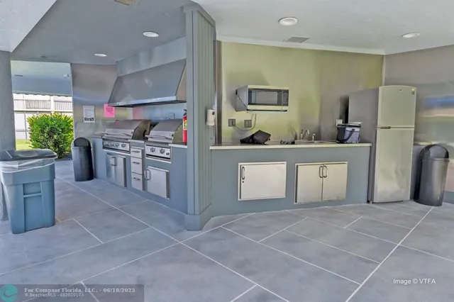 a kitchen with stainless steel appliances a refrigerator sink and stove