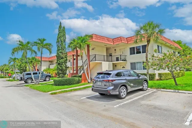 a car parked in front of a house with a yard