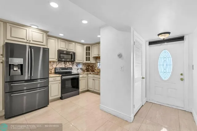 a kitchen with stainless steel appliances a refrigerator stove and microwave
