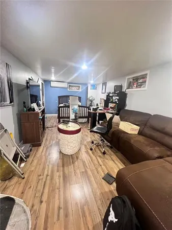 a living room with furniture a flat screen tv and rug