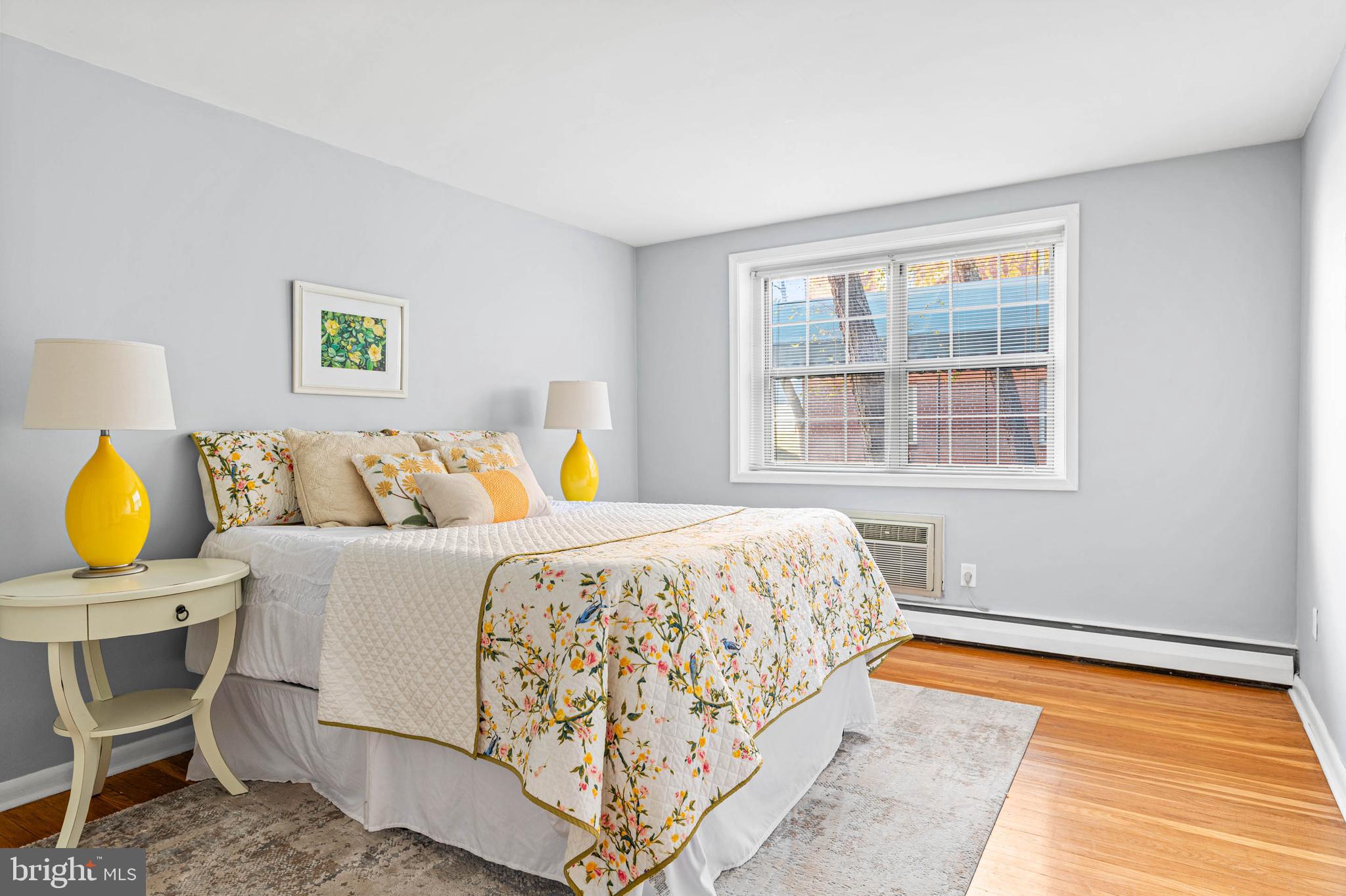 383 Lakeside Road, Unit 105 Ardmore, PA 19003 - Photo 11 of 25 a bedroom with a bed and wooden floor