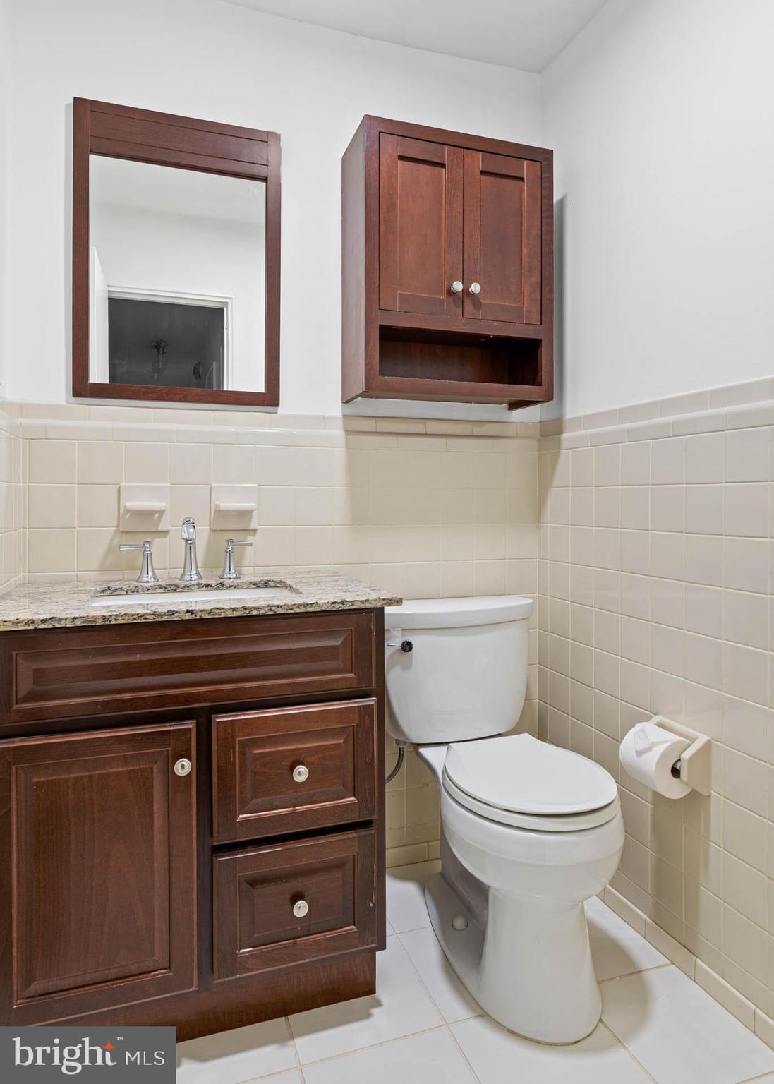 383 Lakeside Road, Unit 105 Ardmore, PA 19003 - Photo 18 of 25 a bathroom with a toilet a sink and mirror