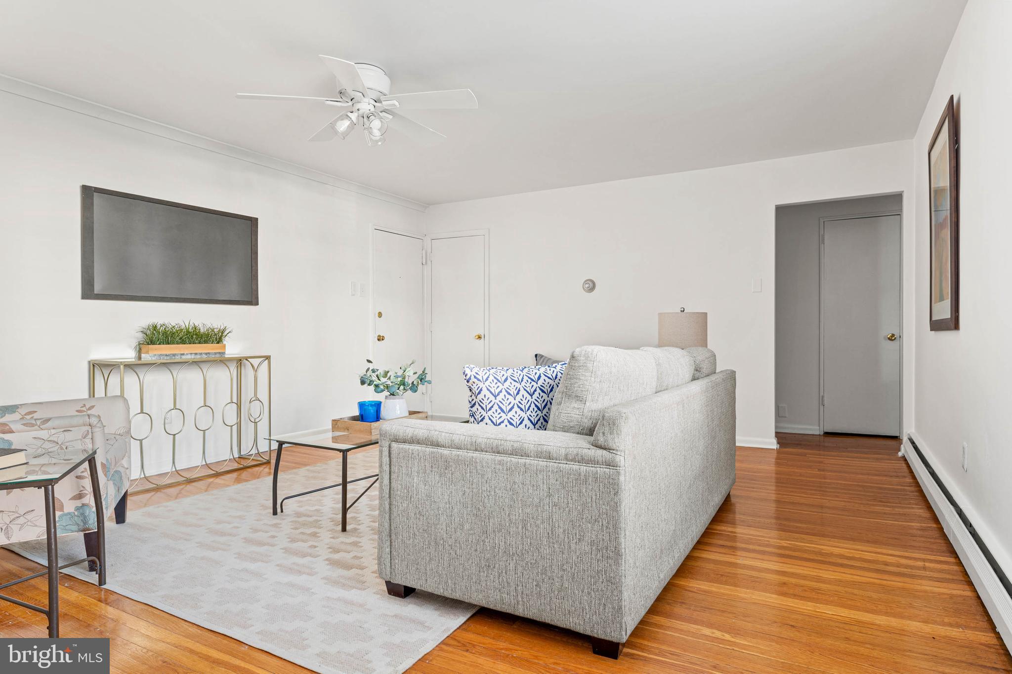 383 Lakeside Road, Unit 105 Ardmore, PA 19003 - Photo 6 of 25 a living room with furniture and a flat screen tv