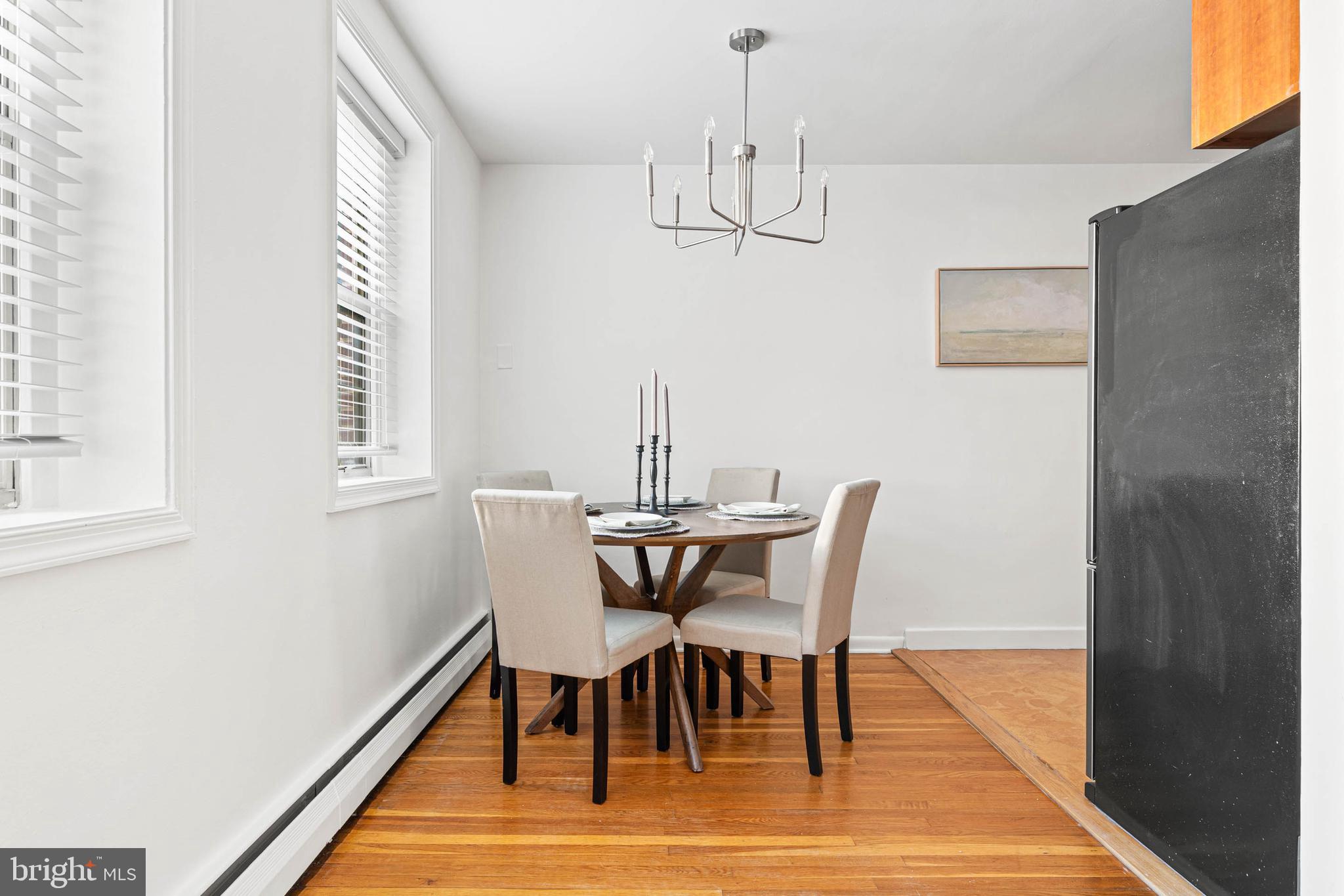 383 Lakeside Road, Unit 105 Ardmore, PA 19003 - Photo 10 of 25 a view of a dining room with furniture wooden floor and chandelier