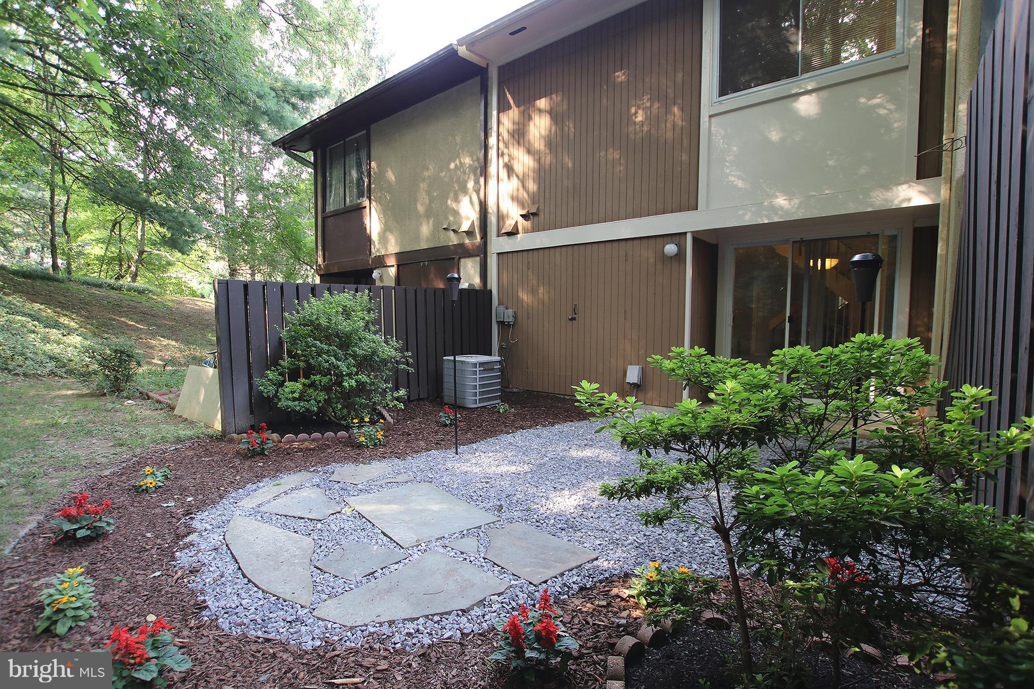 2203 Coppersmith Square Reston, VA 20191 - Photo 1 of 25 a front view of a house with a yard
