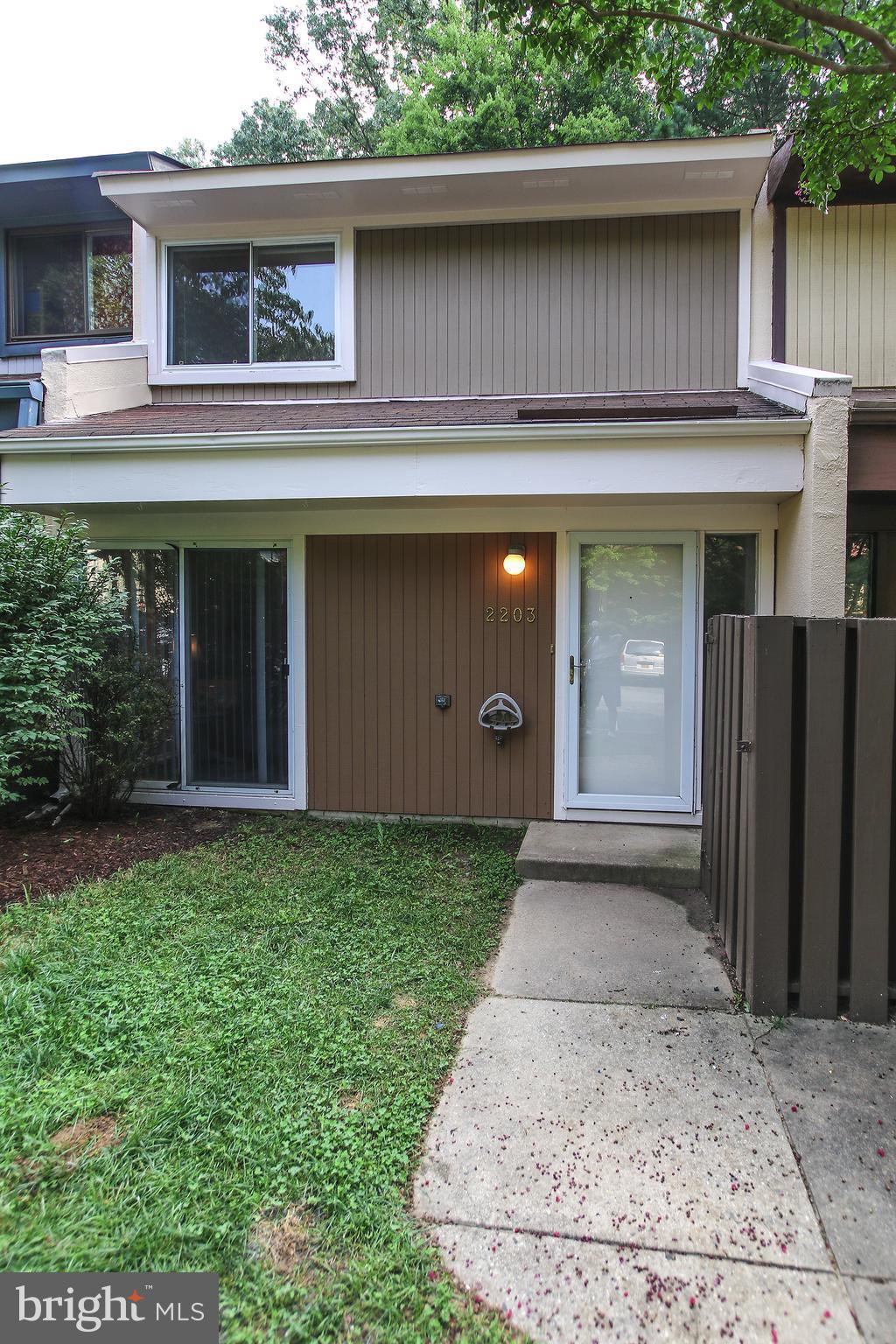 2203 Coppersmith Square Reston, VA 20191 - Photo 2 of 25 a front view of a house with garden