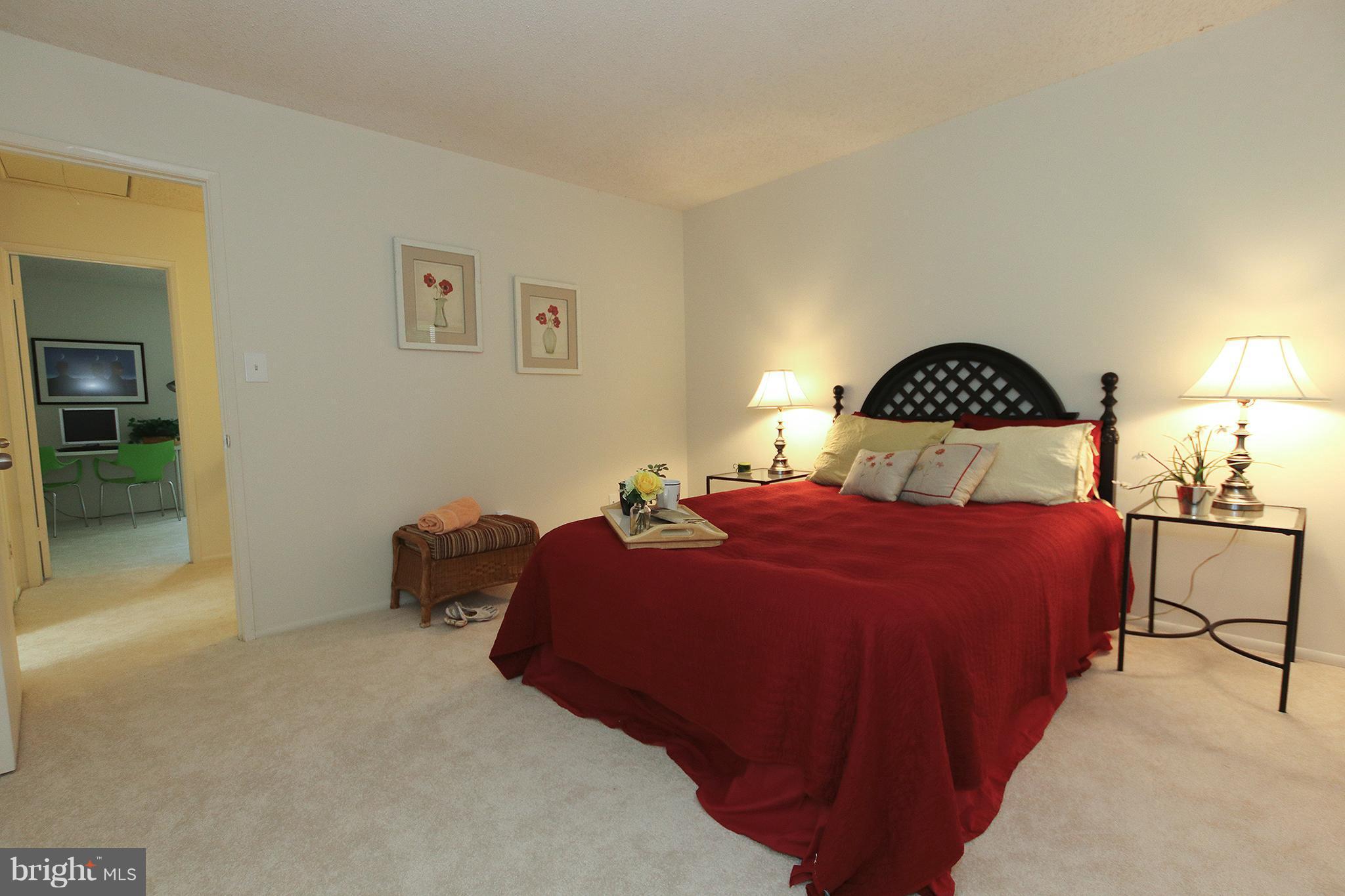 2203 Coppersmith Square Reston, VA 20191 - Photo 12 of 25 a bedroom with a bed and lamp