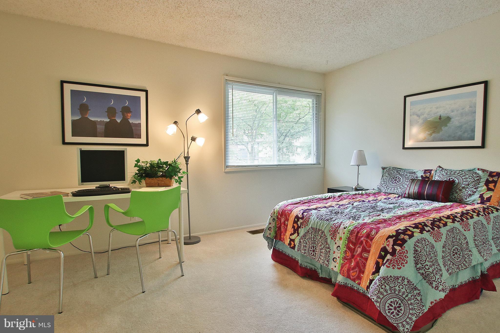 2203 Coppersmith Square Reston, VA 20191 - Photo 16 of 25 a bedroom with a bed and a window
