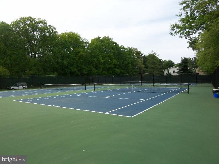 2203 Coppersmith Square Reston, VA 20191 - Photo 23 of 25 a tennis court with view of trees in the background