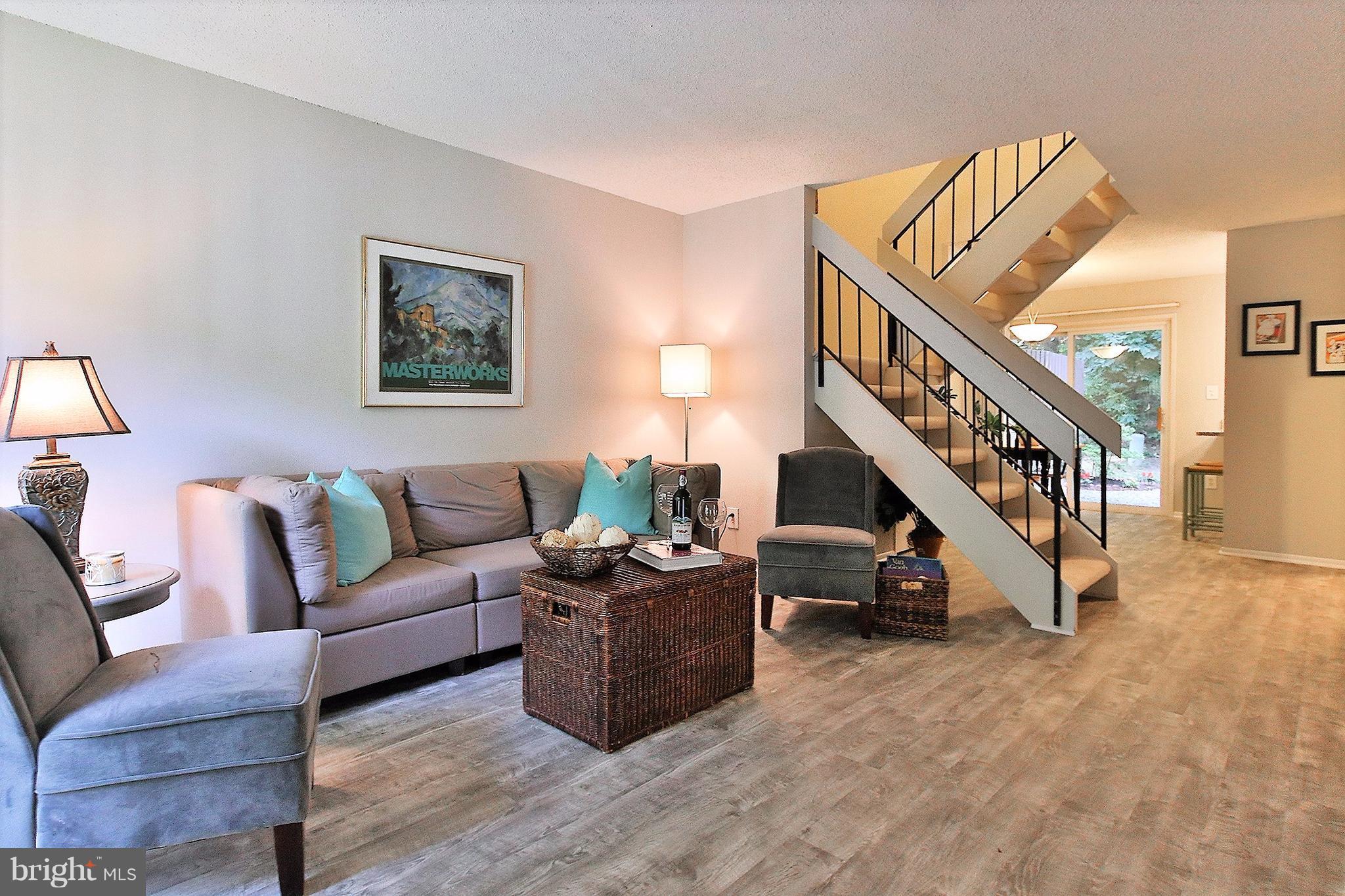 2203 Coppersmith Square Reston, VA 20191 - Photo 5 of 25 a living room with furniture and stairs
