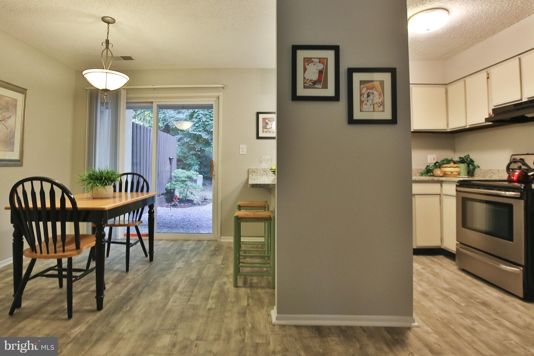 2203 Coppersmith Square Reston, VA 20191 - Photo 6 of 25 a view of kitchen with furniture and wooden floor
