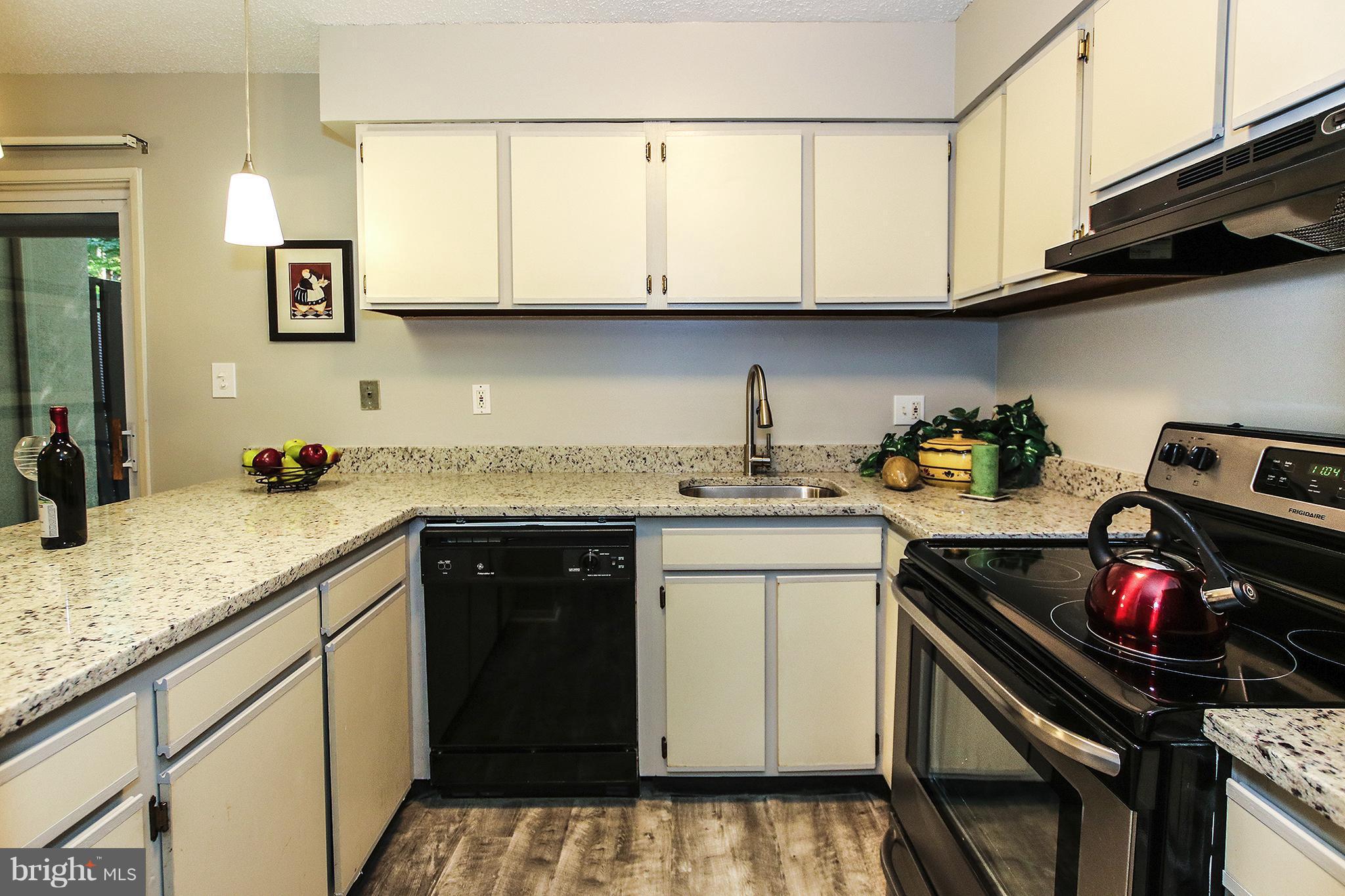 2203 Coppersmith Square Reston, VA 20191 - Photo 7 of 25 a kitchen with stainless steel appliances granite countertop a sink dishwasher stove and cabinets