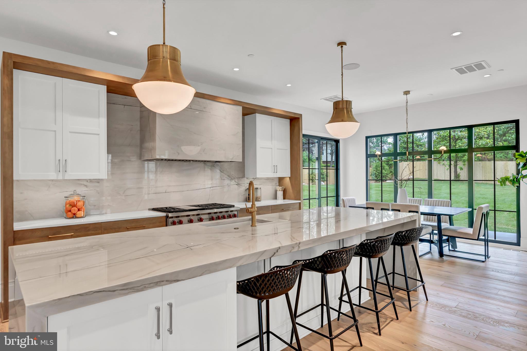 5425 Moorland Lane Bethesda, MD 20814 - Photo 18 of 79 a kitchen with stainless steel appliances granite countertop a sink a stove and a wooden floors