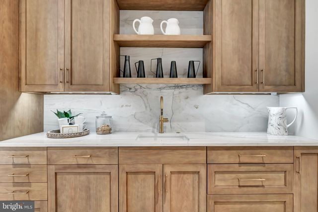 a bathroom with a tub a double vanity sink a window and a shower