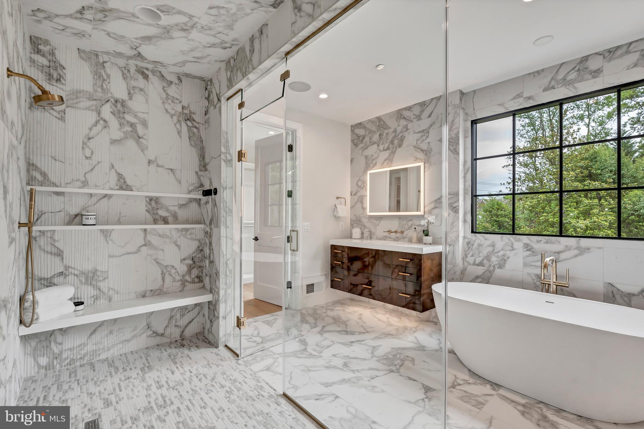 5425 Moorland Lane Bethesda, MD 20814 - Photo 42 of 79 a bathroom with a tub a double vanity sink a window and a shower