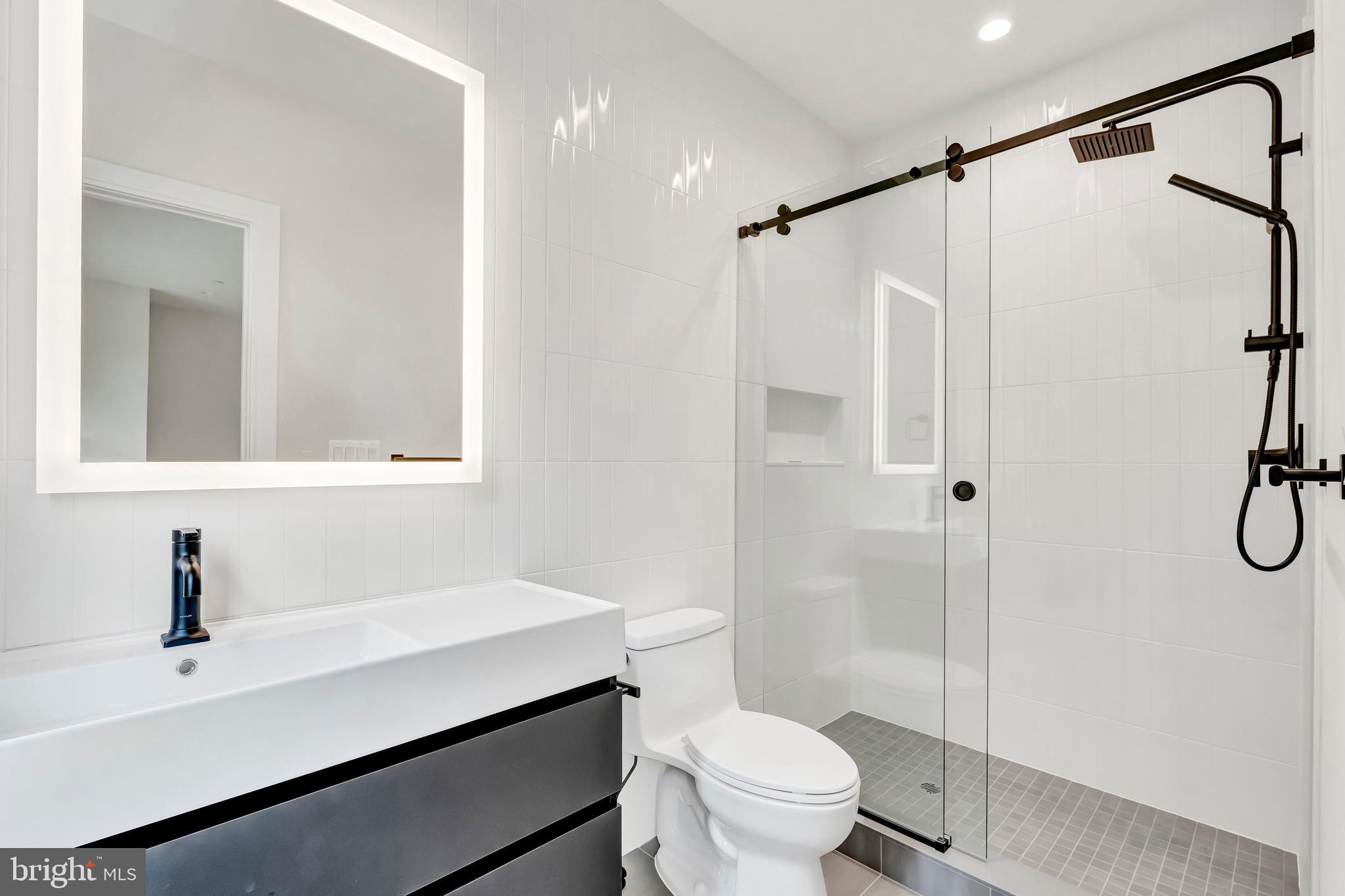 5425 Moorland Lane Bethesda, MD 20814 - Photo 52 of 79 a bathroom with a sink a toilet and shower