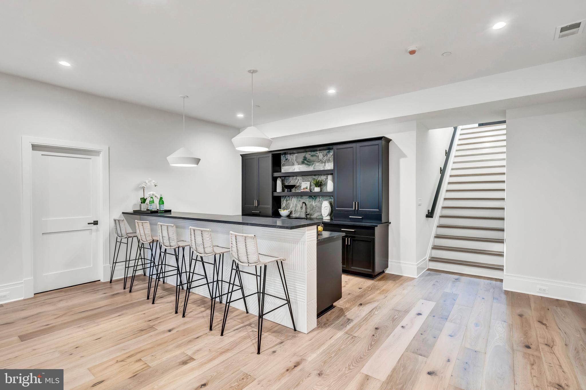 5425 Moorland Lane Bethesda, MD 20814 - Photo 57 of 79 a kitchen with stainless steel appliances a kitchen island hardwood floor sink and wooden floor
