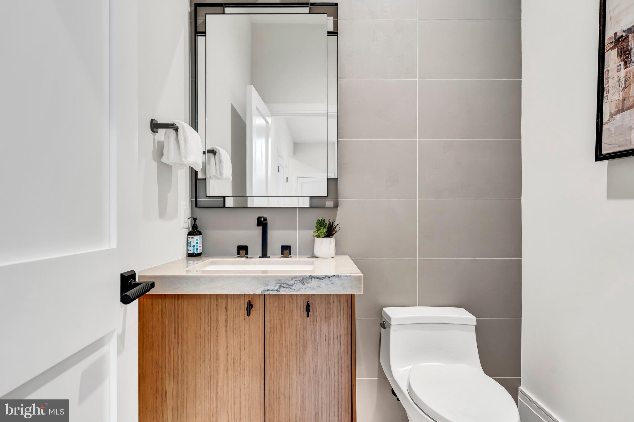 5425 Moorland Lane Bethesda, MD 20814 - Photo 60 of 79 a bathroom with a sink a toilet and a mirror