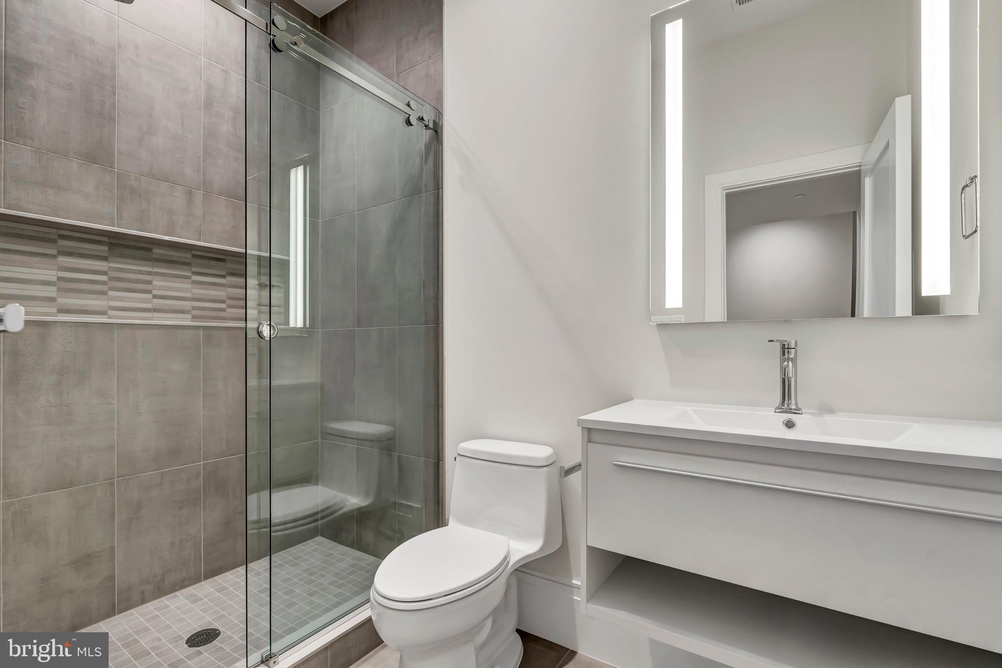 5425 Moorland Lane Bethesda, MD 20814 - Photo 67 of 79 a bathroom with a sink toilet and shower