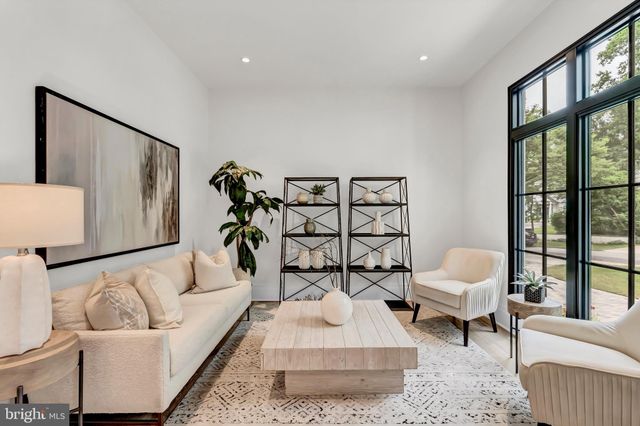 a dining room with furniture potted plants and wooden floor