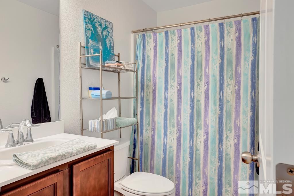 929 Estuary Circle Reno, NV 89506 - Photo 11 of 30 a bathroom with a granite countertop sink and a mirror