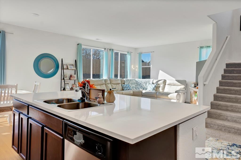 929 Estuary Circle Reno, NV 89506 - Photo 9 of 30 a kitchen with kitchen island a sink appliances and a counter top space