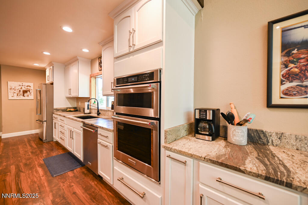 1147 Autumn Hills Road Gardnerville, NV 89460 - Photo 17 of 53 a kitchen with stainless steel appliances granite countertop a sink and a stove