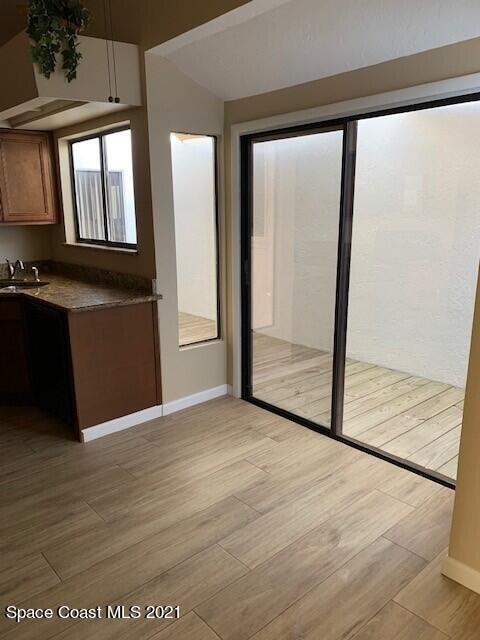 381 Myrtlewood Road Melbourne, FL 32940 - Photo 11 of 31 an empty room with wooden floor and windows