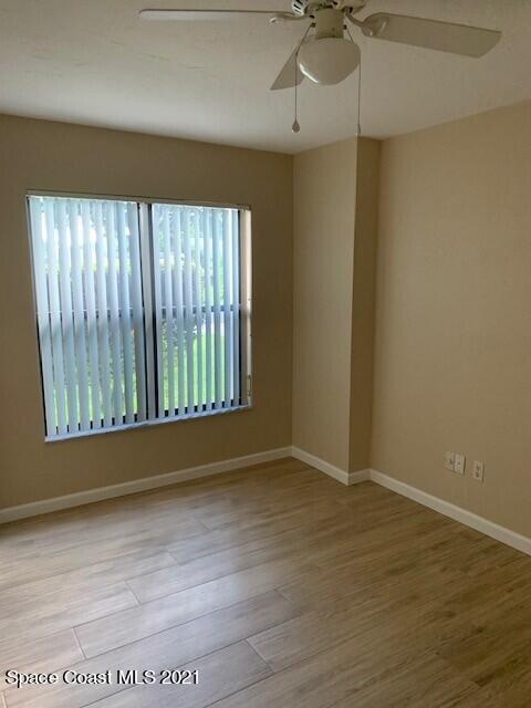 381 Myrtlewood Road Melbourne, FL 32940 - Photo 17 of 31 wooden floor in an empty room with a window
