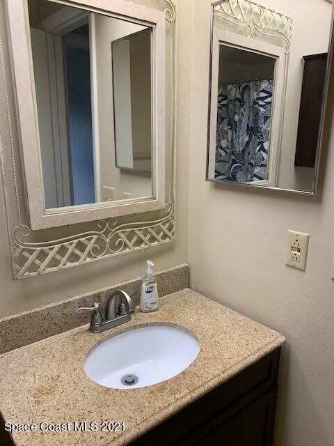 381 Myrtlewood Road Melbourne, FL 32940 - Photo 19 of 31 a bathroom with a sink and a mirror