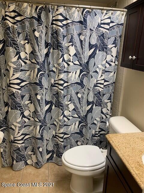 381 Myrtlewood Road Melbourne, FL 32940 - Photo 20 of 31 a white toilet sitting next to a shower curtain