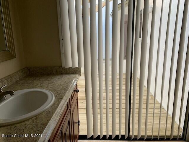 381 Myrtlewood Road Melbourne, FL 32940 - Photo 26 of 31 a bathroom with a granite countertop sink and a mirror