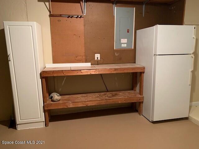 381 Myrtlewood Road Melbourne, FL 32940 - Photo 28 of 31 a bathroom with a sink and a refrigerator