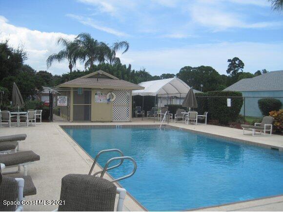 381 Myrtlewood Road Melbourne, FL 32940 - Photo 31 of 31 a front view of a house with swimming pool having outdoor seating