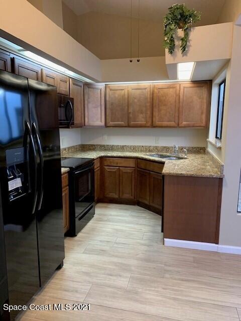 381 Myrtlewood Road Melbourne, FL 32940 - Photo 9 of 31 a kitchen with stainless steel appliances granite countertop a sink and cabinets