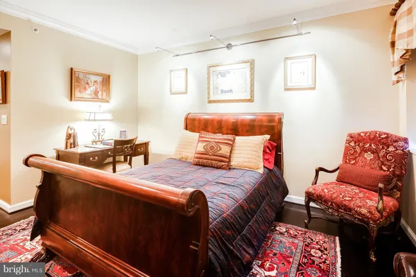 a bedroom with a bed and a couch