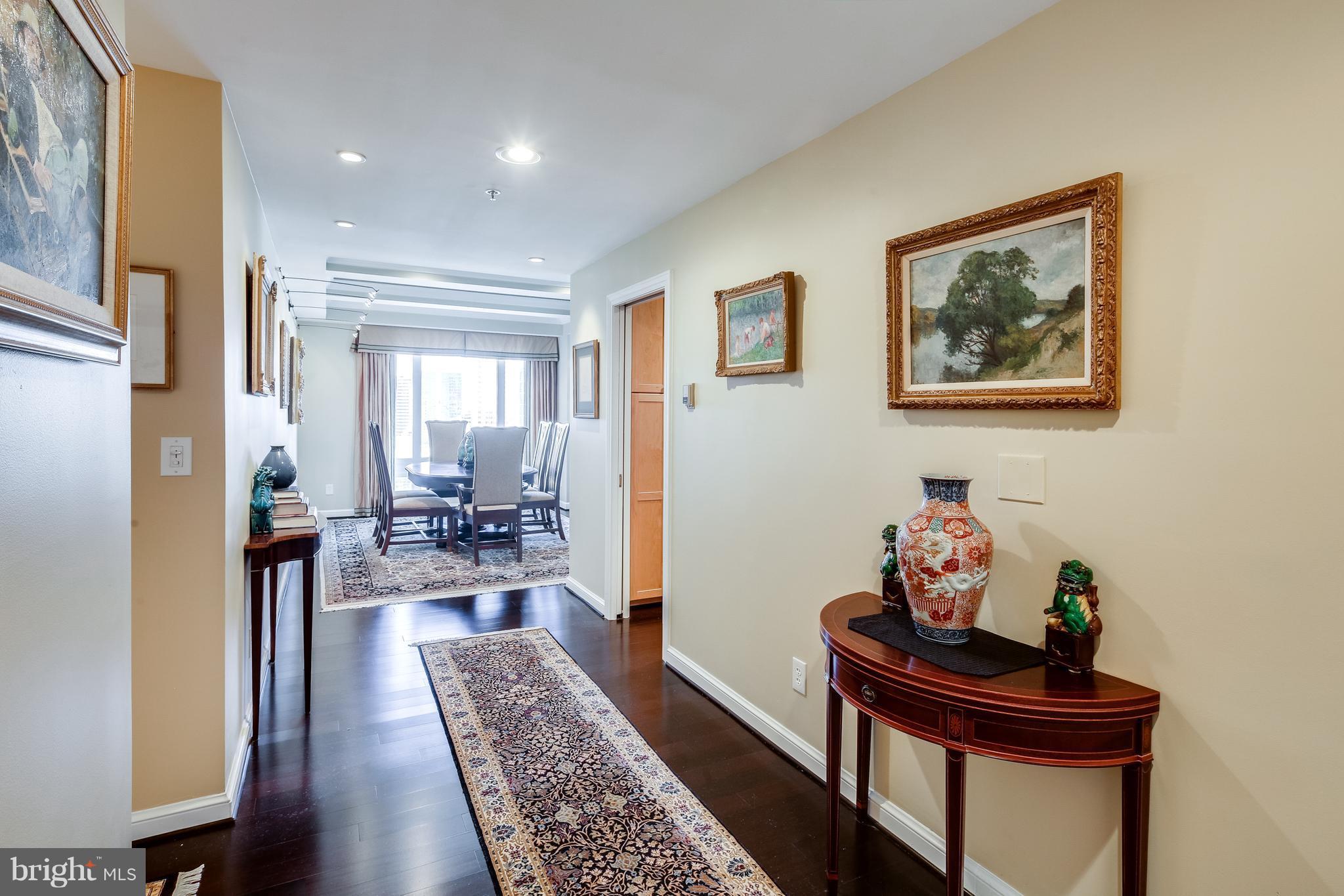10 East Lee Street, Unit 1802 Baltimore, MD 21202 - Photo 2 of 21 a living room with furniture and wooden floor