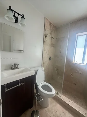 a bathroom with a sink toilet and shower