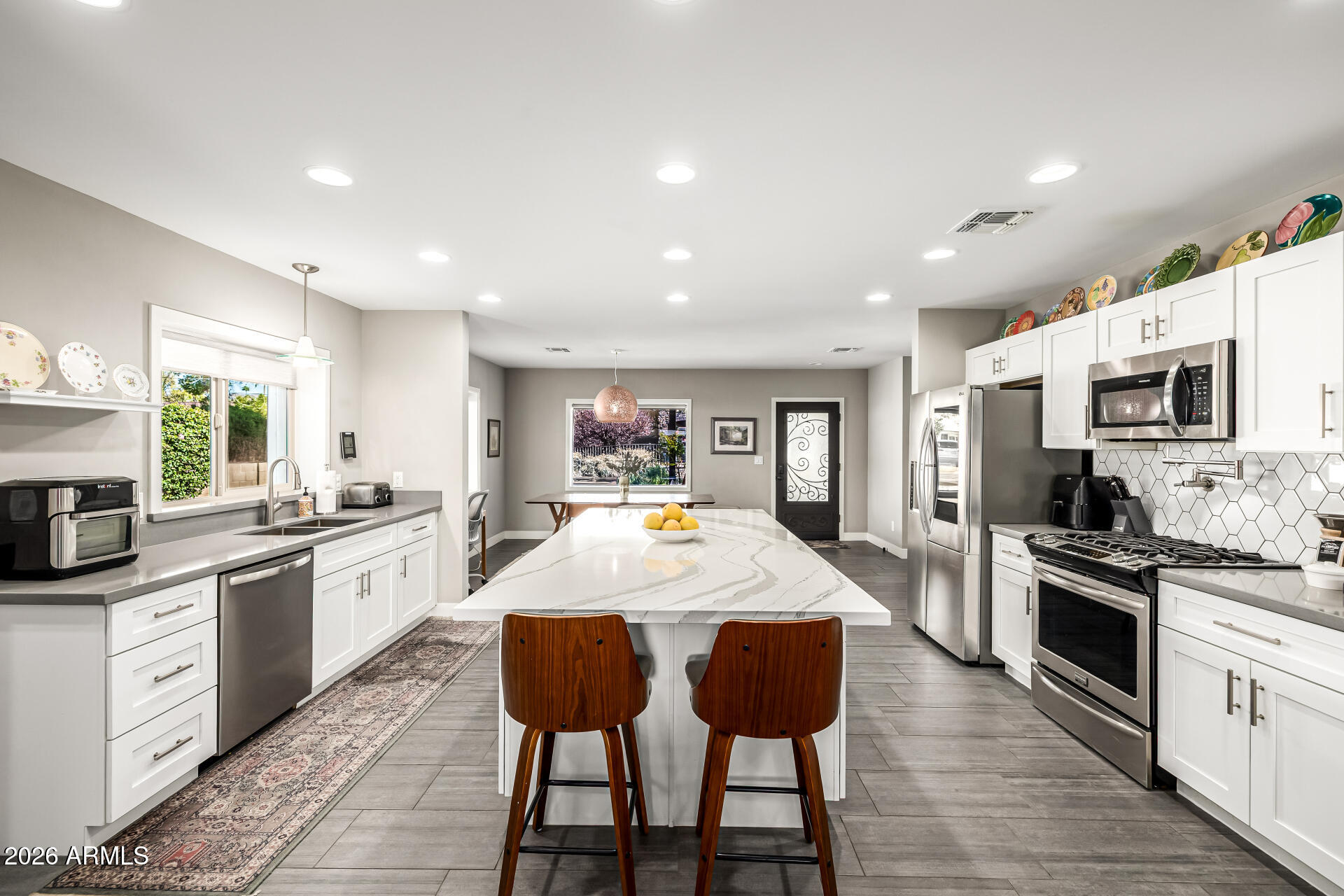 6726 North 11th Street Phoenix, AZ 85014 - Photo 14 of 49 a large kitchen with granite countertop lots of counter top space and stainless steel appliances
