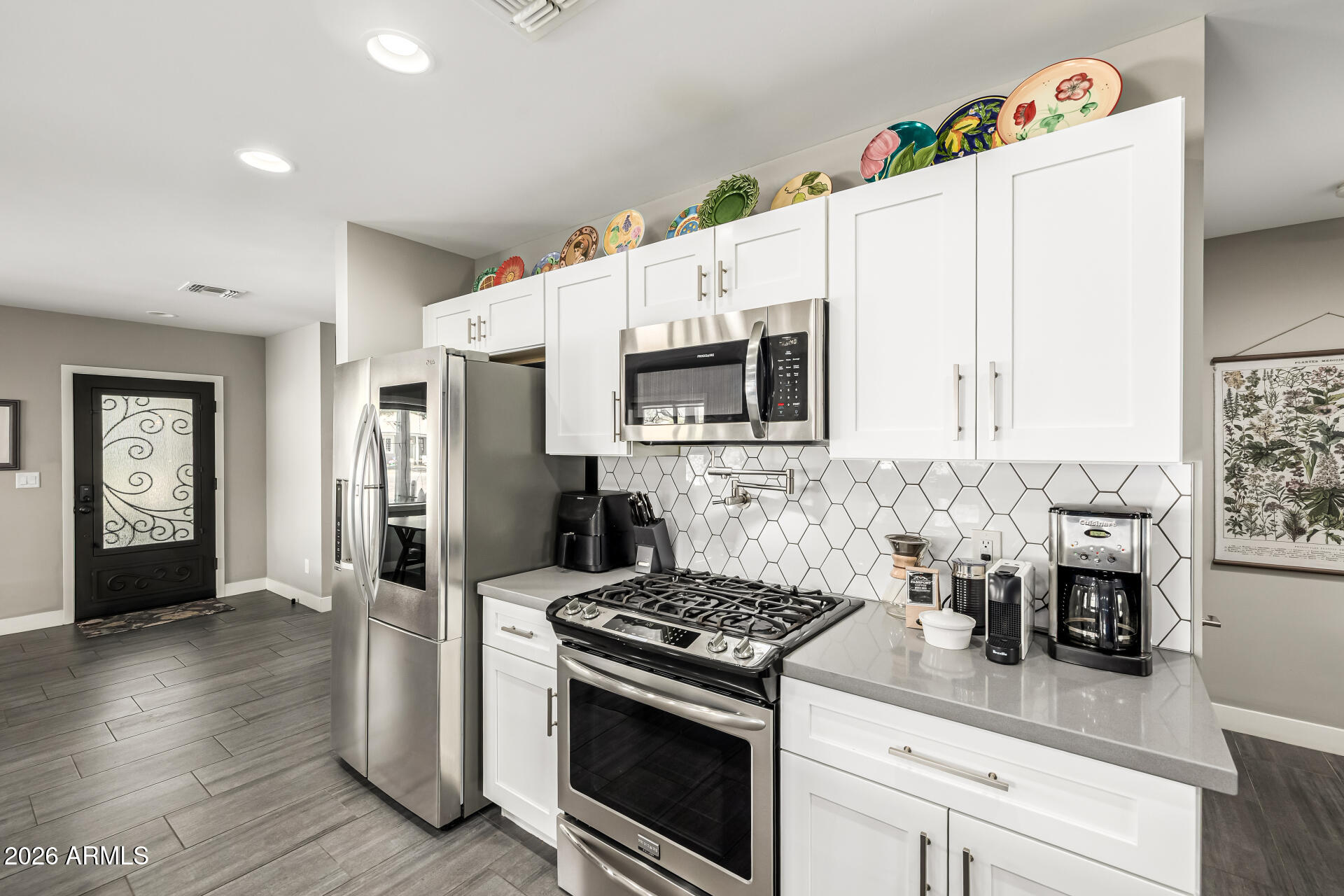 6726 North 11th Street Phoenix, AZ 85014 - Photo 16 of 49 a kitchen with granite countertop a sink stove and refrigerator