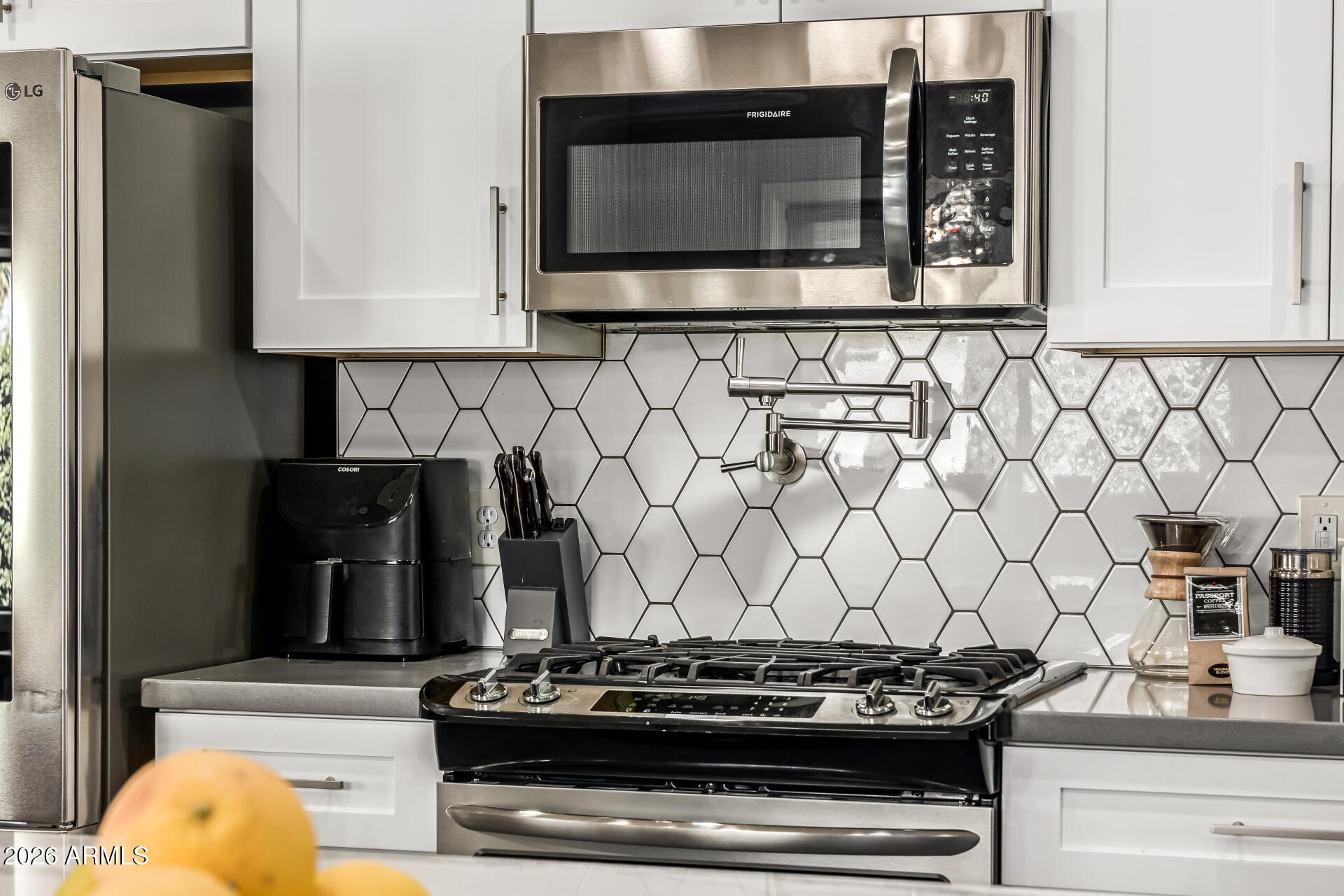 6726 North 11th Street Phoenix, AZ 85014 - Photo 18 of 49 a kitchen with stainless steel appliances granite countertop a stove and a microwave oven