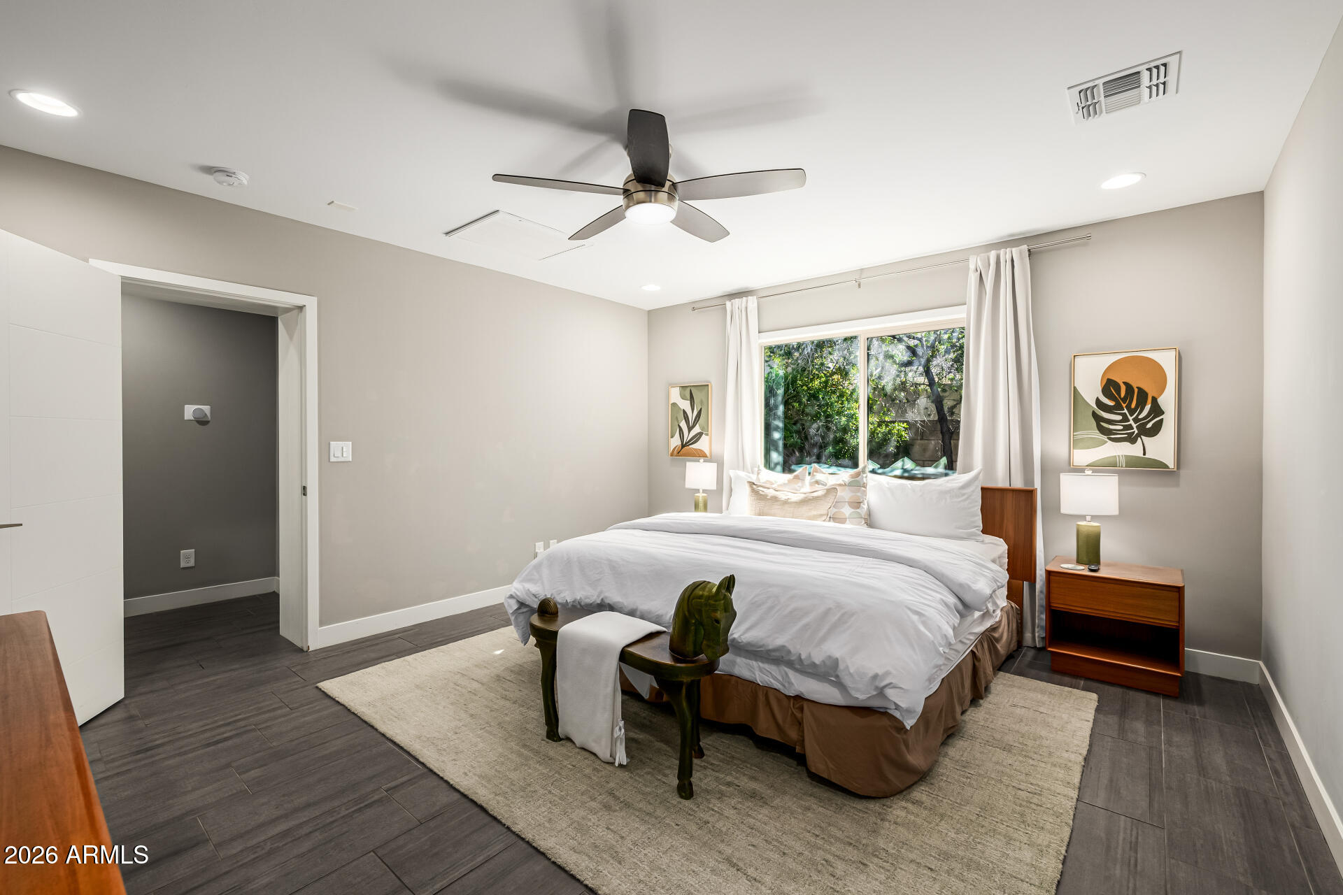 6726 North 11th Street Phoenix, AZ 85014 - Photo 20 of 49 a bedroom with a bed wooden floor and window