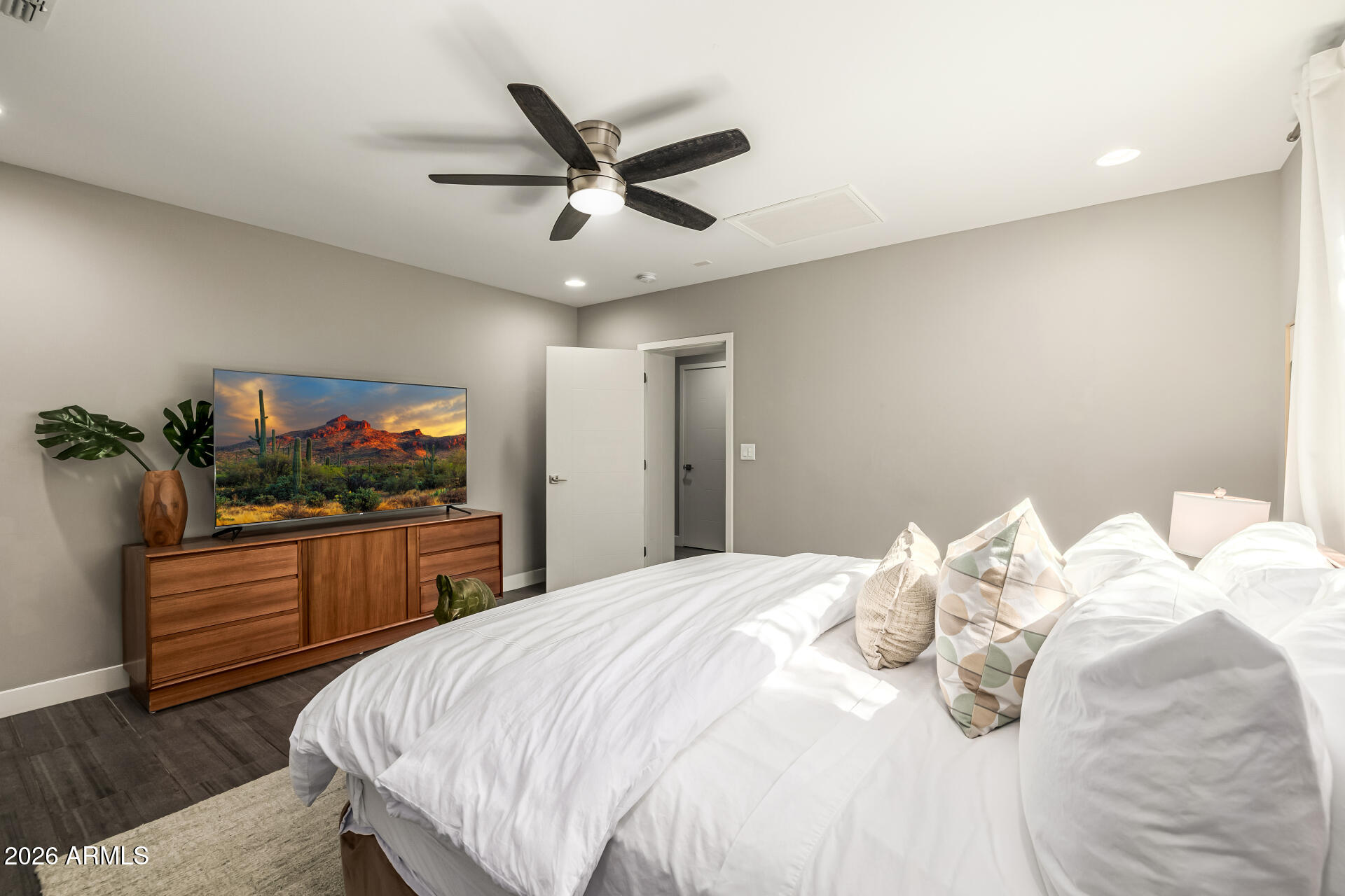 6726 North 11th Street Phoenix, AZ 85014 - Photo 21 of 49 a bedroom with a bed and a flat screen tv