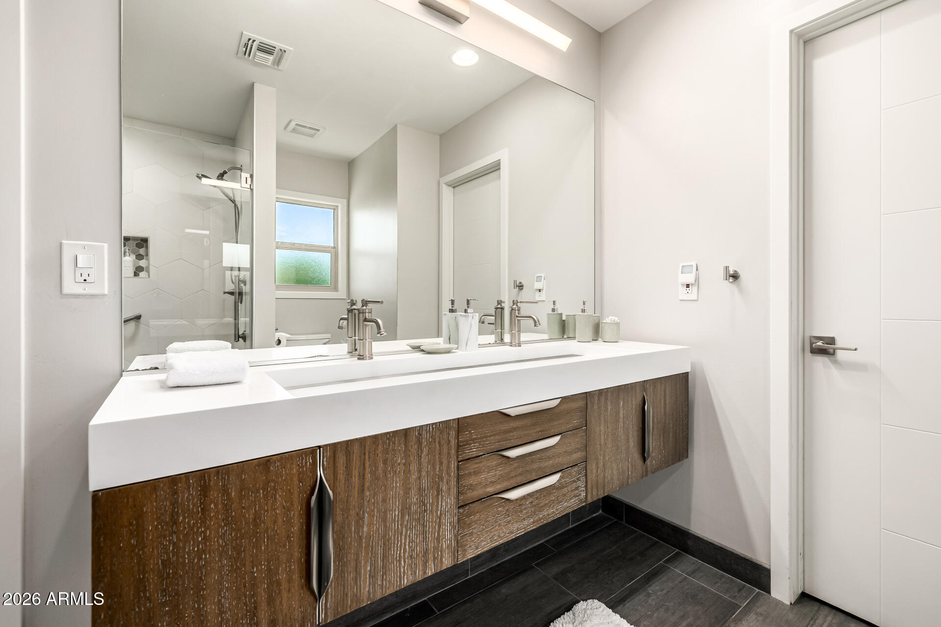 6726 North 11th Street Phoenix, AZ 85014 - Photo 24 of 49 a bathroom with a sink double vanity and a mirror